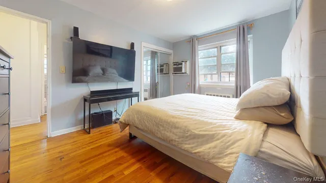 a bedroom with a bed and wooden floor