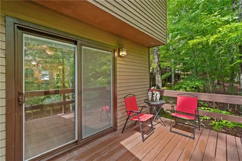 a patio with lawn chairs and wooden floor