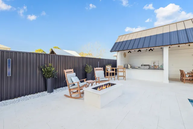 a living room with furniture and a painting on the wall