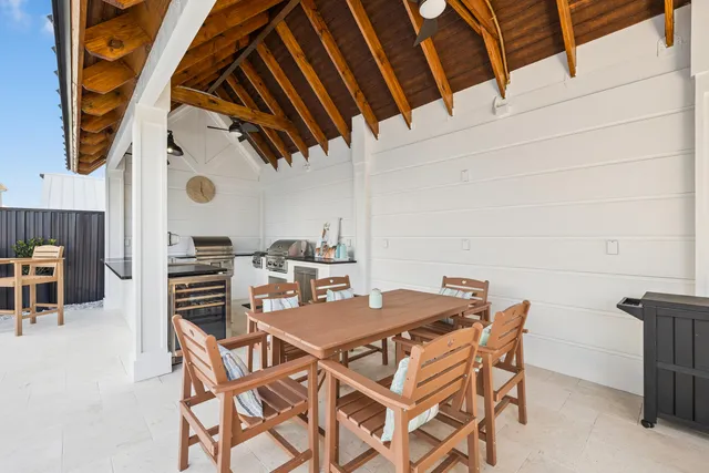 a view of a bedroom with wooden floor and white walls