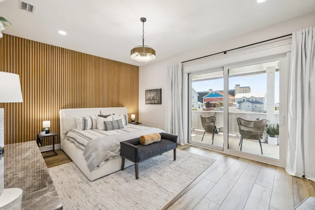 a view of bedroom with furniture and wooden floor