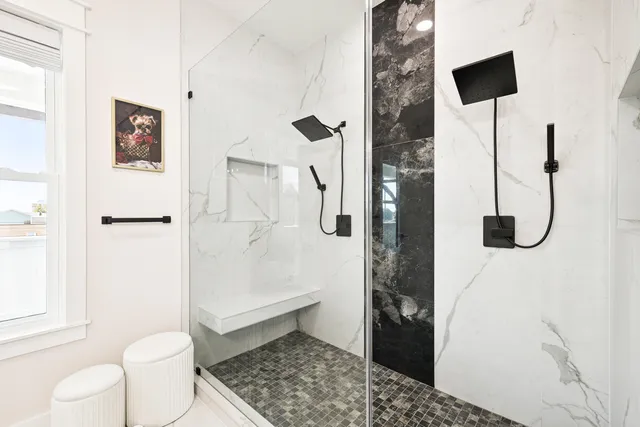 a dining room with furniture a potted plant and a mirror