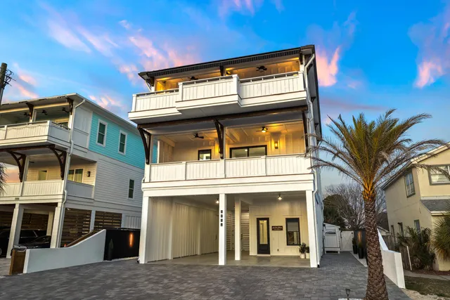 a view of a patio with table and chairs with wooden fence