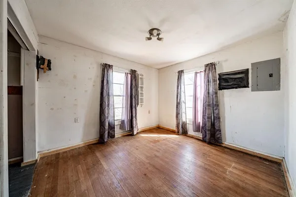 a view of a livingroom with furniture window wooden floor and chandelier