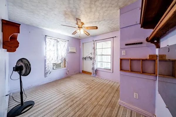 a view of a wooden door with a bench in patio