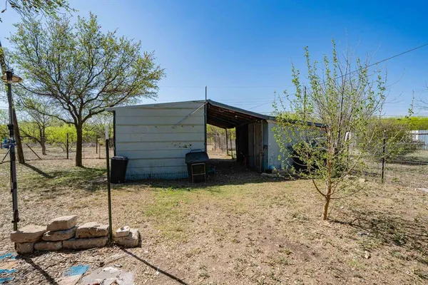 a view of a yard with large trees