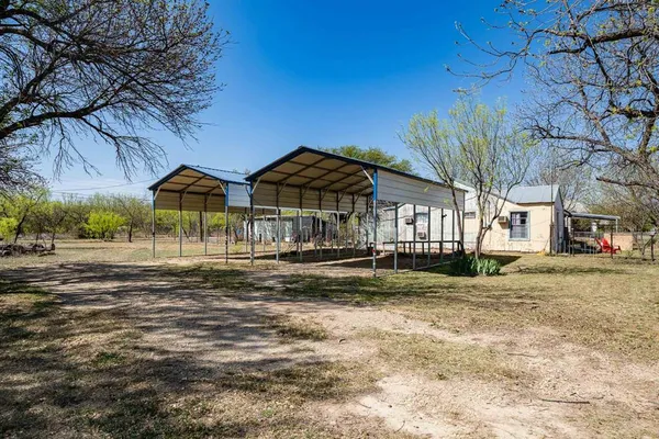 a patio with a table and chairs under an umbrella