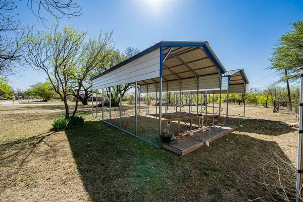 a view of a backyard with sitting area