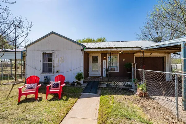 a view of two chairs in front of house