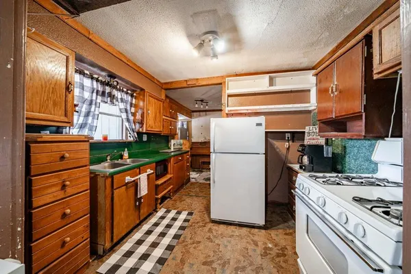 a kitchen with refrigerator a stove and cabinets