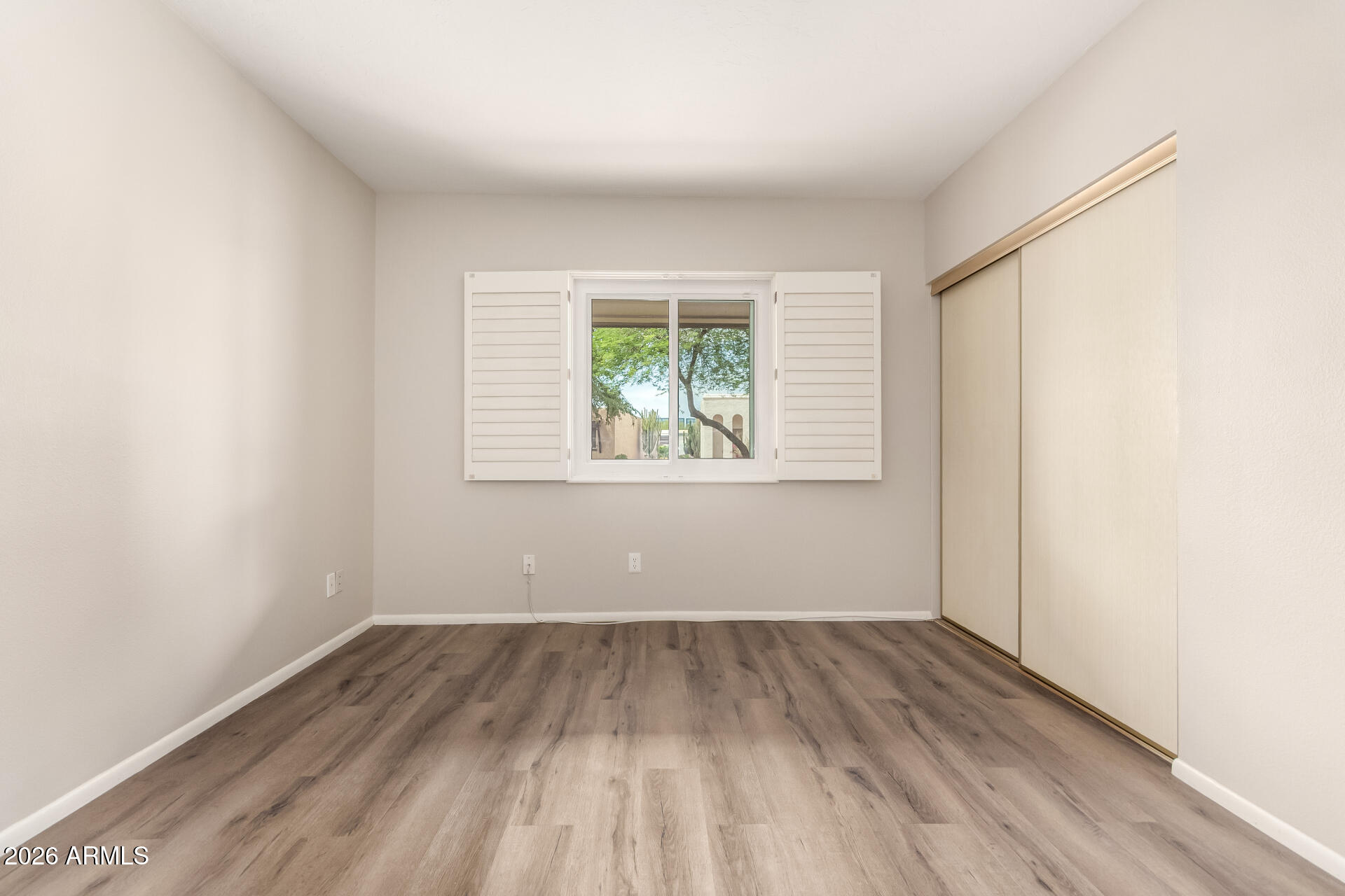 1833 West Citrus Way Phoenix, AZ 85015 - Photo 9 of 36 an empty room with wooden floor and windows