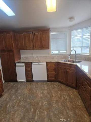 a kitchen with wooden cabinets and sink