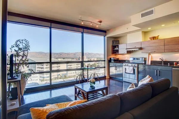 a living room with furniture and a floor to ceiling window