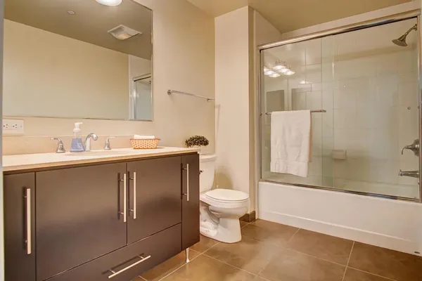 a bathroom with a sink toilet and shower