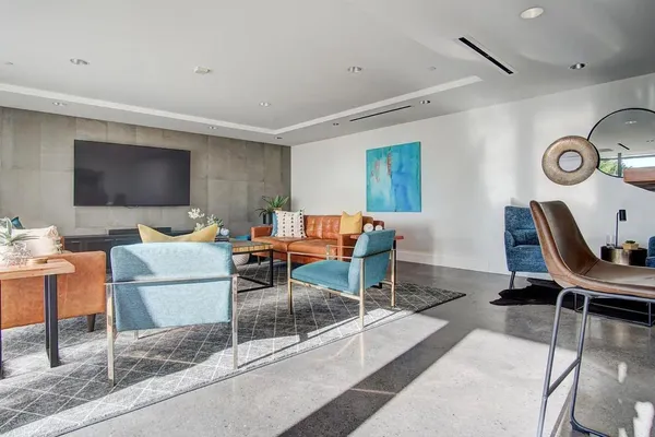 a view of a dining room with furniture and a flat screen tv