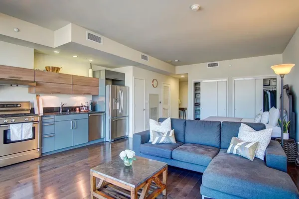 a living room with furniture and kitchen view