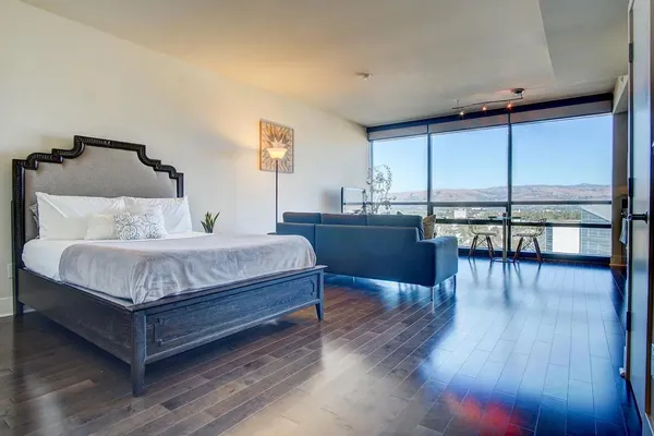 a bedroom with a bed and wooden floor