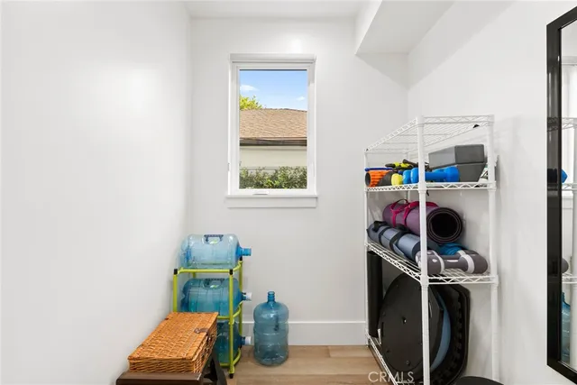 a view of storage and utility room with two washing machine