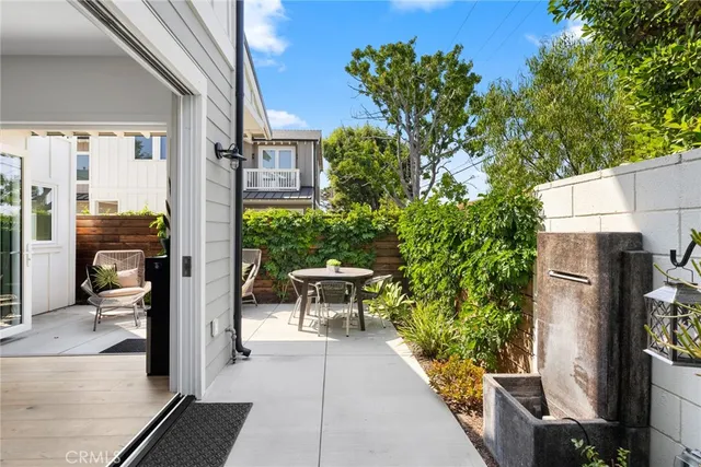 a view of a patio with table and chairs and potted plants