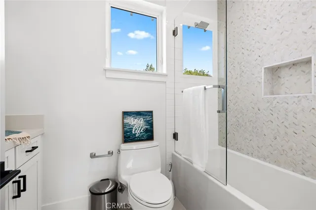 a bathroom with a toilet a sink and shower