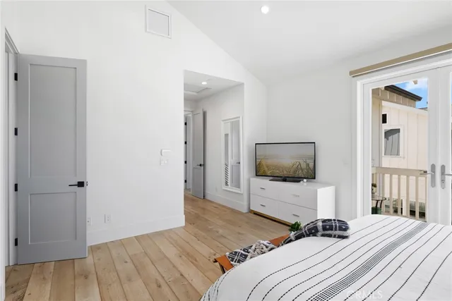 a bedroom with a bed and flat screen tv