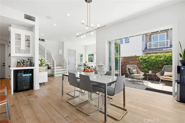 a living room with furniture a fireplace and a chandelier