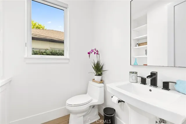 a bathroom with a sink toilet and mirror