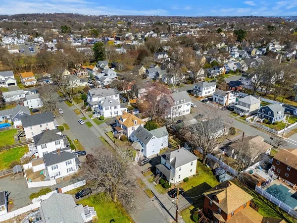 an aerial view of residential building with parking