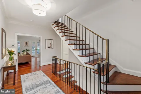 a view of staircase with wooden floor and a rug