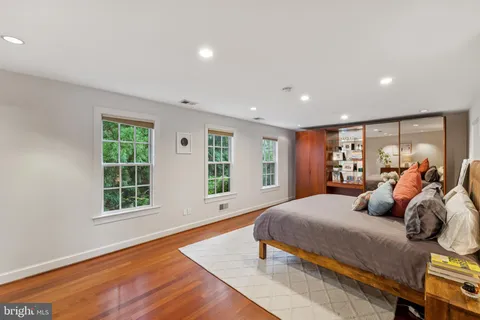 a bedroom with a large bed and a window