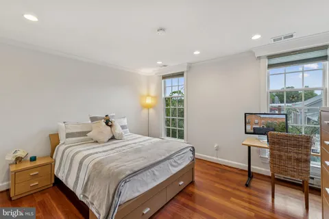 a bedroom with a bed and a chair