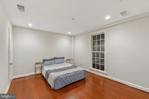 a spacious bedroom with a bed and a window