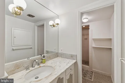 a bathroom with a sink vanity and a mirror