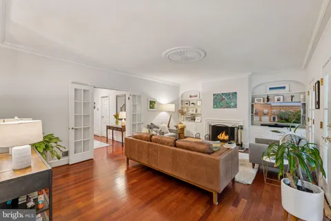 a living room with furniture a wooden floor and a fireplace