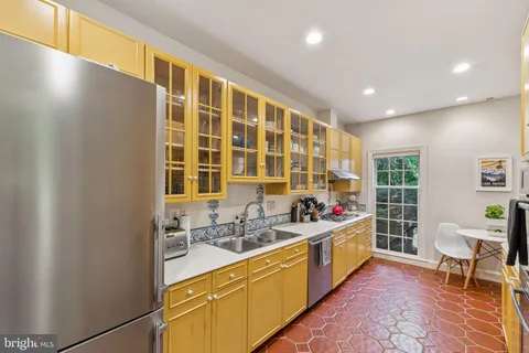 a kitchen with a sink and wooden cabinets
