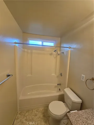 a bathroom with a toilet and shower