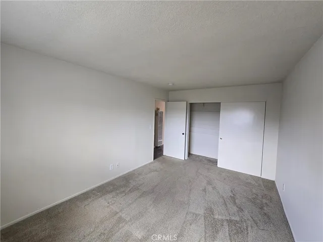 a view of an empty room and a window