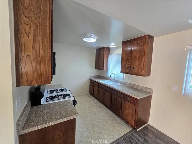 a kitchen with stainless steel appliances granite countertop a sink stove and cabinets