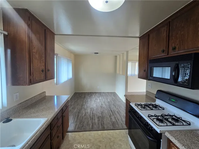 a kitchen with granite countertop a stove and a sink