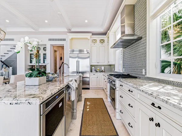 a kitchen with stainless steel appliances granite countertop sink stove and cabinets