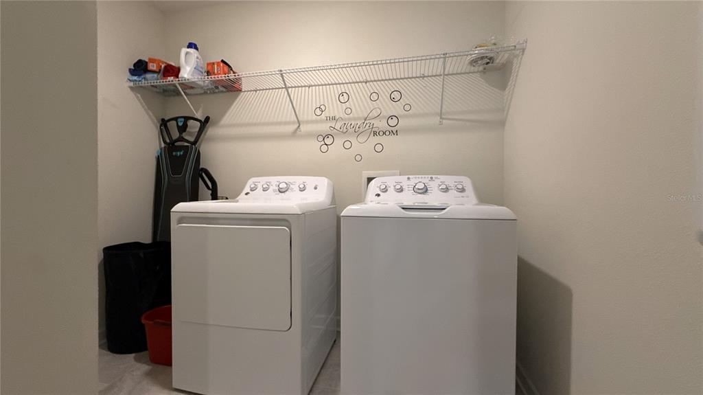 1055 Blackwolf Run Road Davenport, FL 33896 - Photo 12 of 23 a utility room with dryer and washer