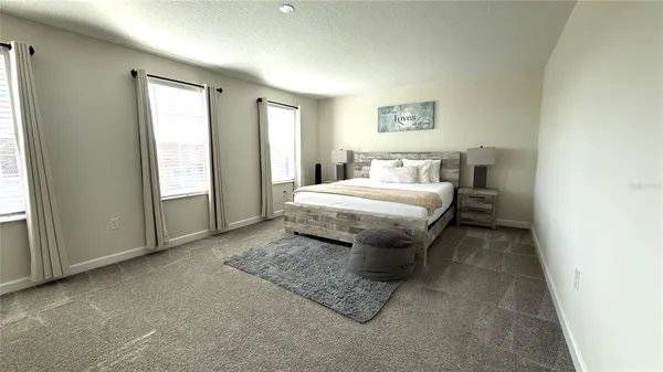a bathroom with a granite countertop sink a toilet and shower