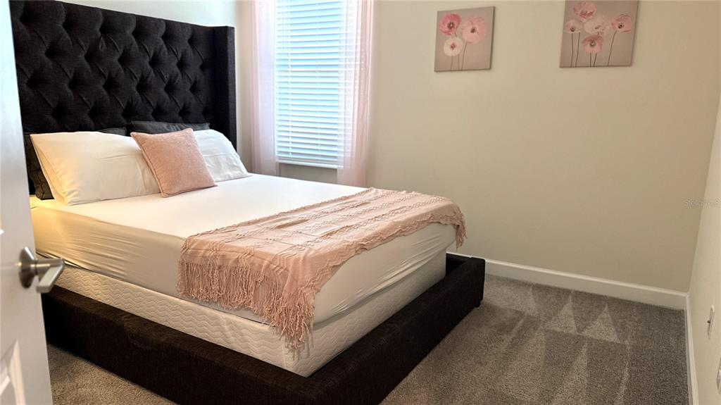 1055 Blackwolf Run Road Davenport, FL 33896 - Photo 10 of 23 a bedroom with a bed and wall painting