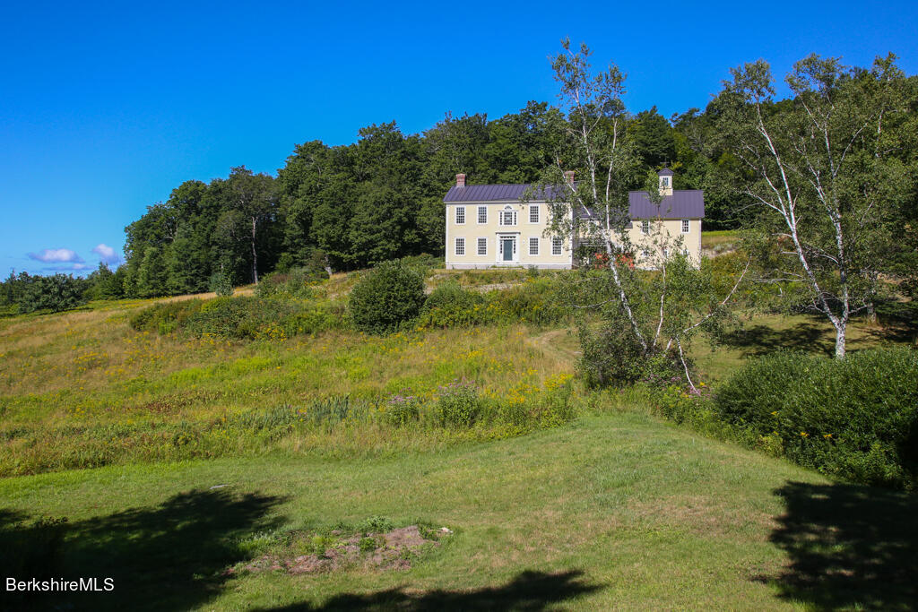 a view of a houses with an outdoor space and seating