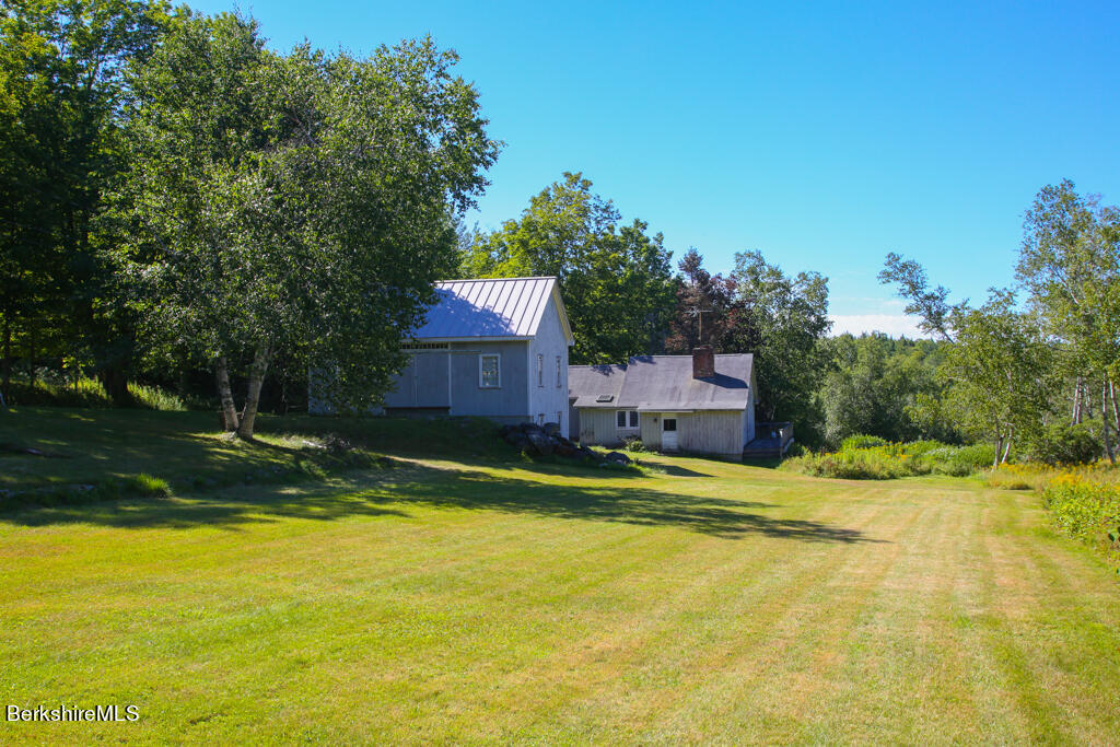 147 Sumner Stetson Road Heath, MA 01339 - Photo 30 of 37 a house view with swimming pool and trees in the background