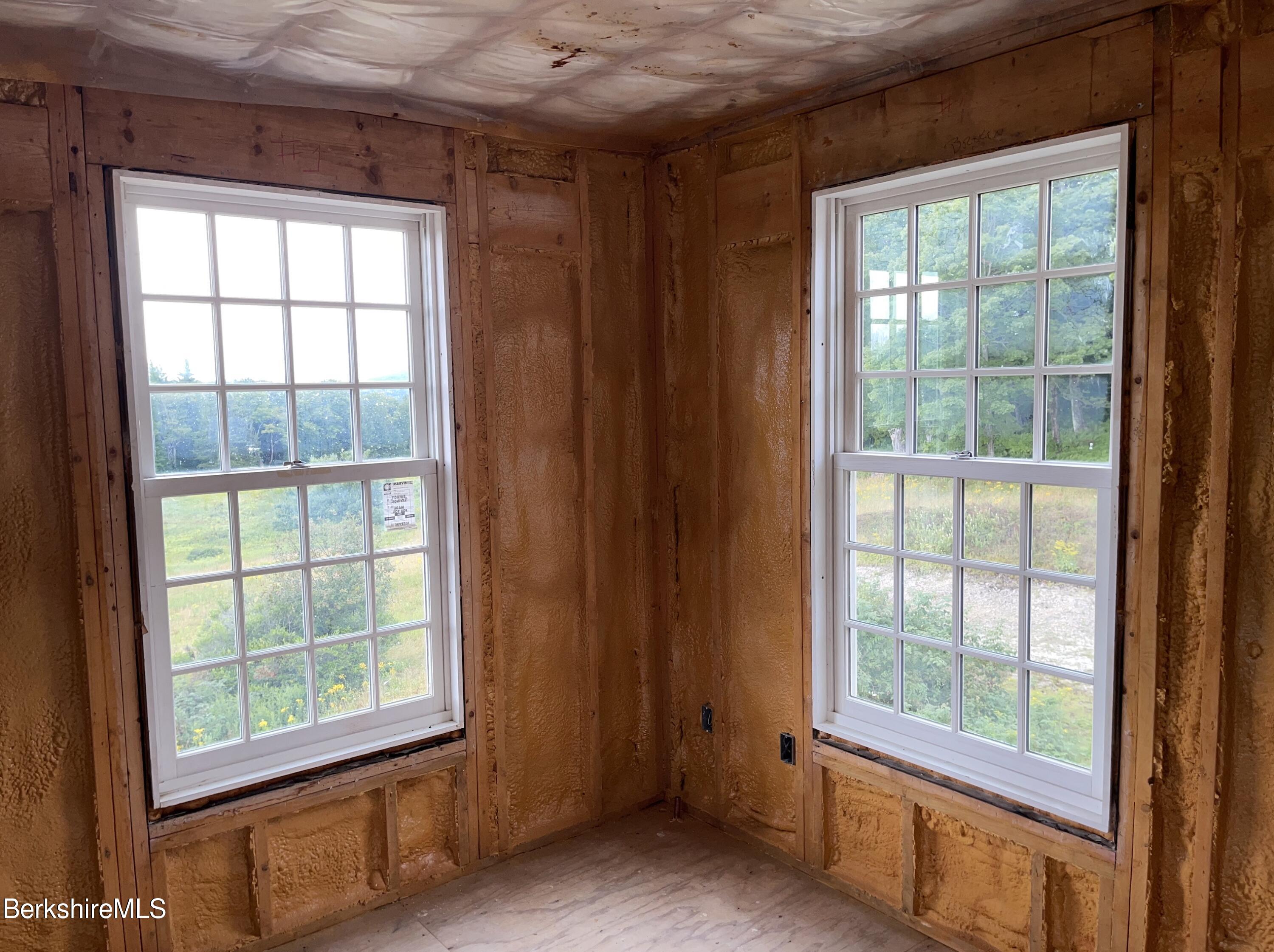 147 Sumner Stetson Road Heath, MA 01339 - Photo 9 of 37 an empty room with large windows