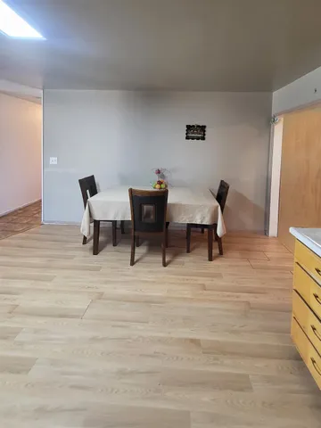 a kitchen with stainless steel appliances kitchen island granite countertop a sink and a refrigerator