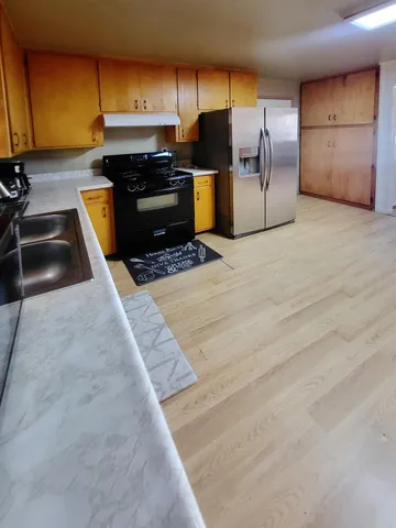 a bed sitting in a room next to a lamp