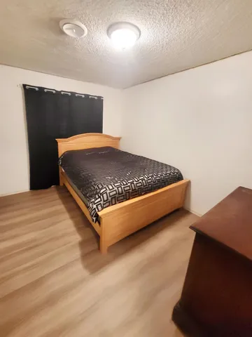 a bedroom with bed and window