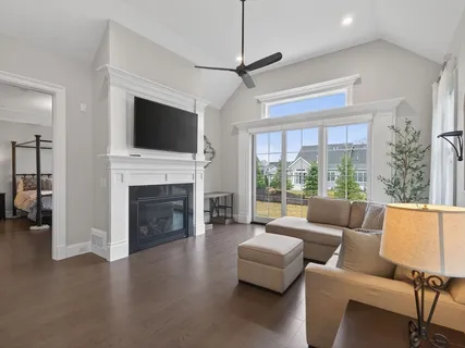 a living room with furniture a fireplace and a flat screen tv
